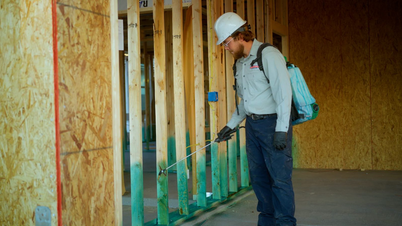 Bucksworth technician applying termite pre-treatment to new construction framing